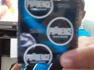 Big-dicked dude trying on a condom